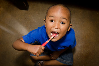Kid brushing his teeth
