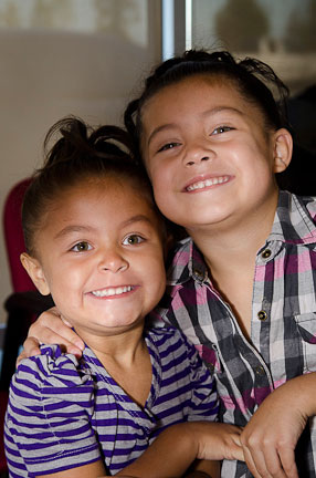 Two young sisters smiling
