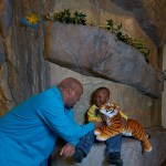 Dr. Gillespie with his son while his son holds a tiger stuffed animal