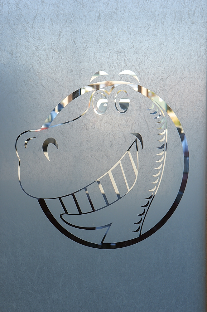 Dinosaur logo etched in glass