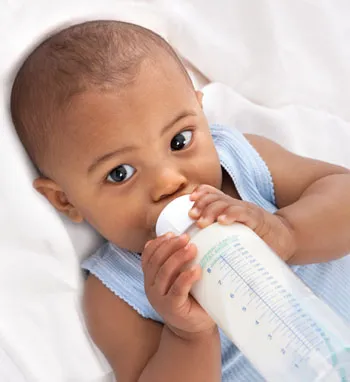 Baby holding a bottle