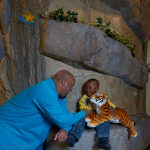 Dr. Gillespie with his son while his son holds a tiger stuffed animal