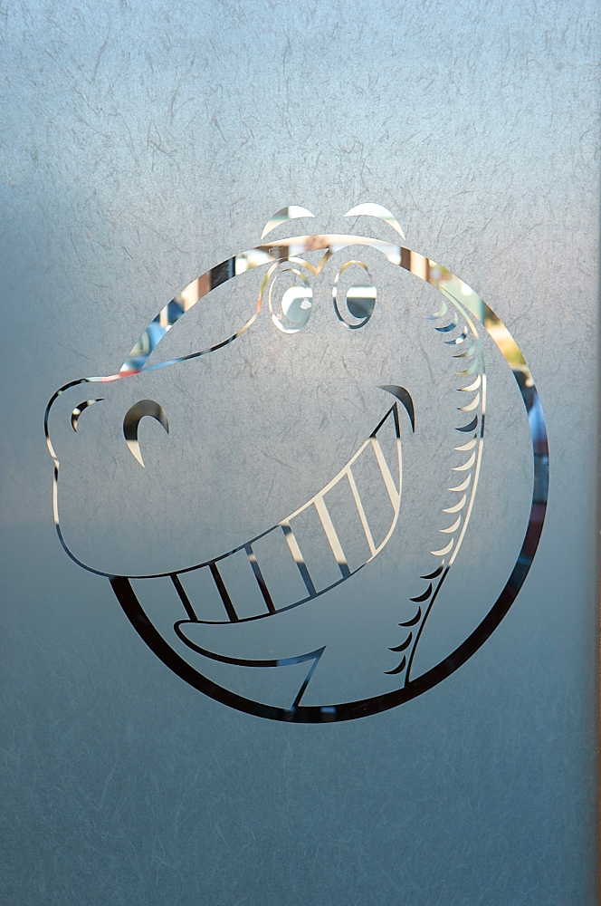 Dinosaur logo etched in glass