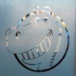 Dinosaur logo etched in glass
