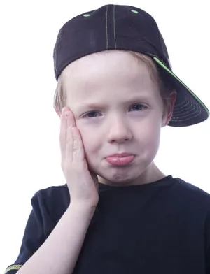 Child holding the side of his cheek in discomfort