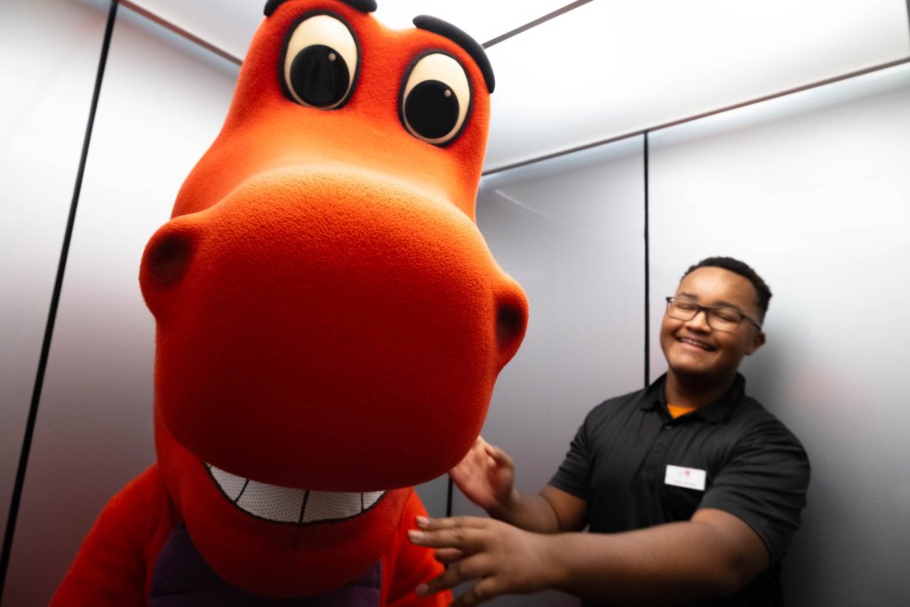 Mascot  photo in orange with staff